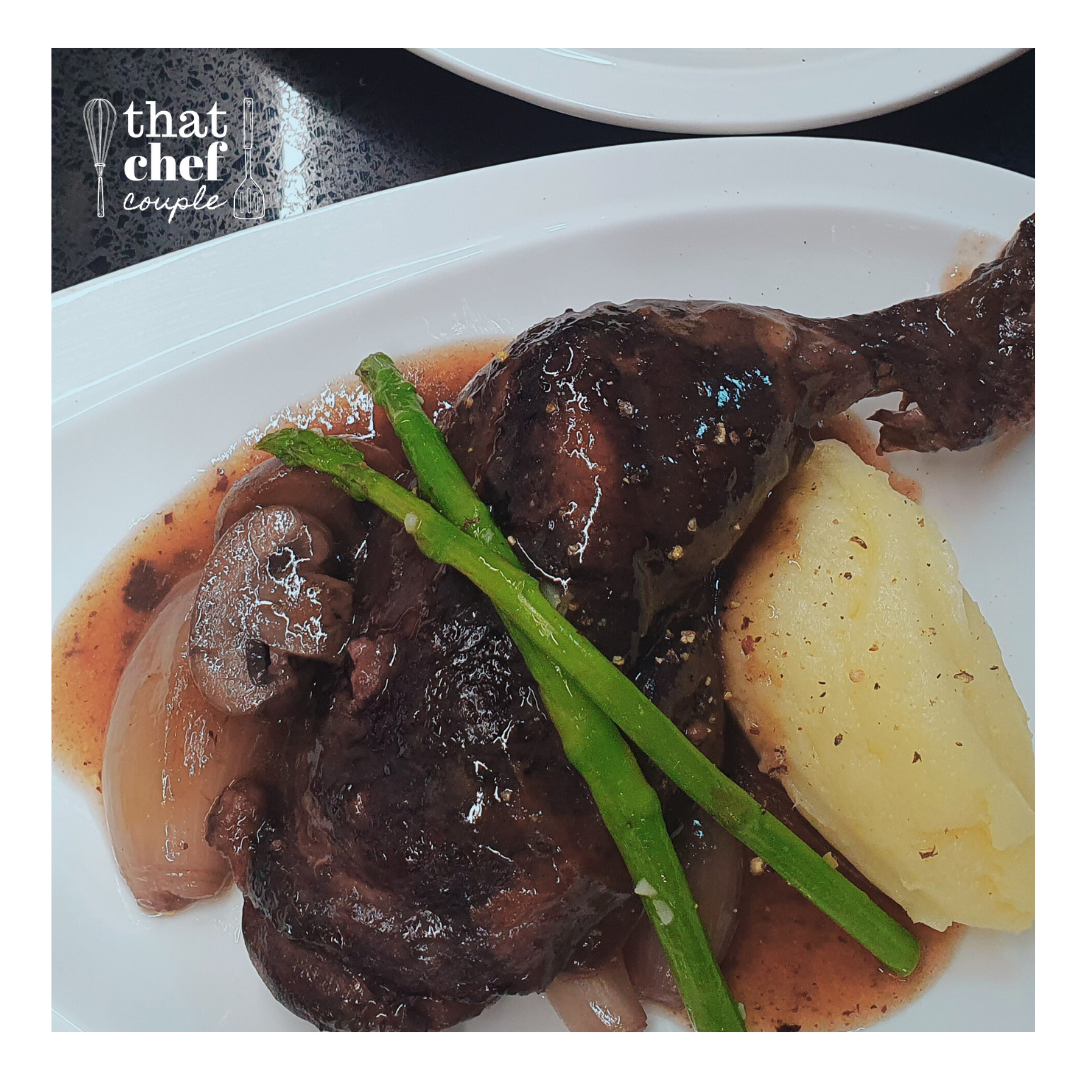 coq au vin with buttery mash and sauteed asparagus spears