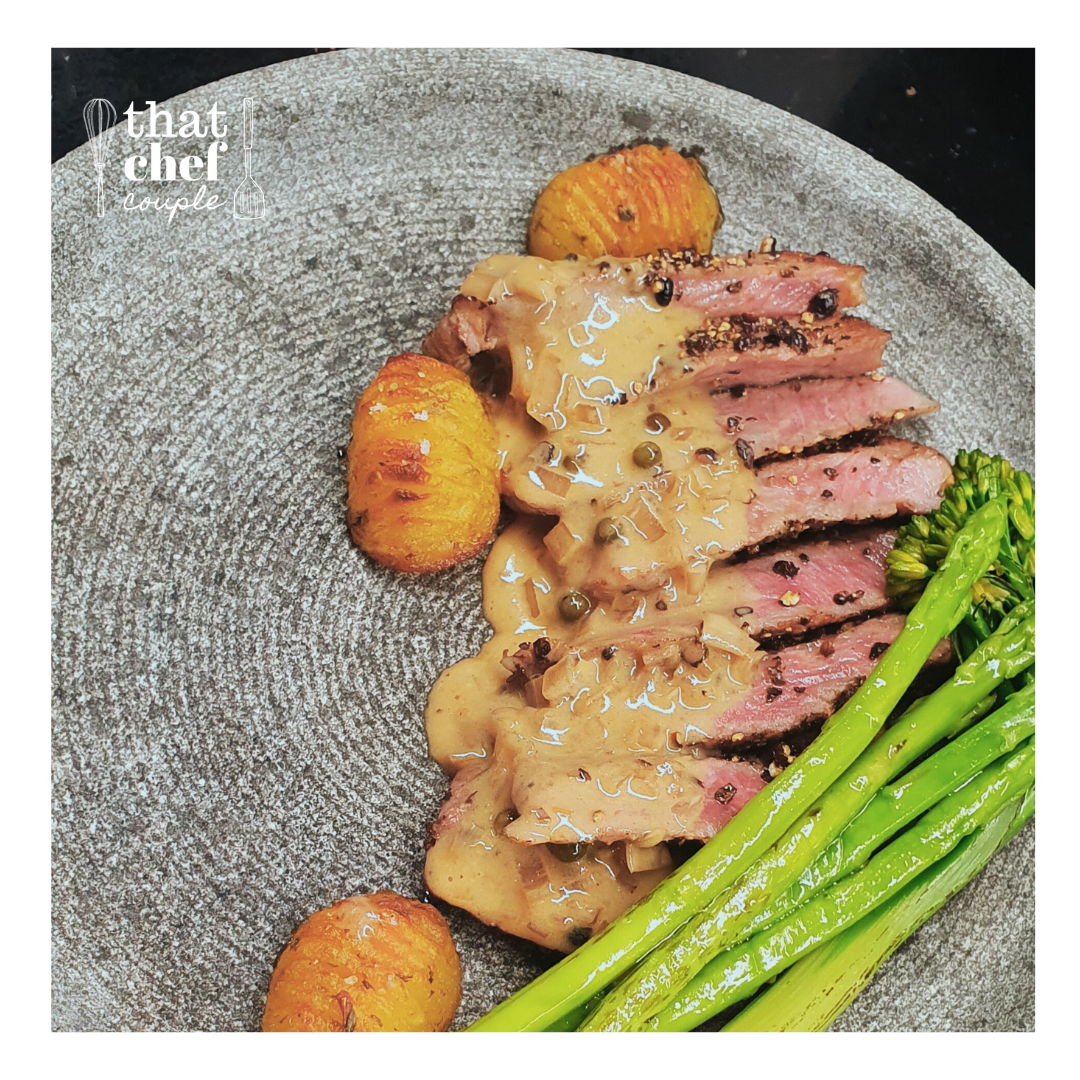 Steak au-poivre with hasselback potatoes, sauteed vegetables, and cognac sauce