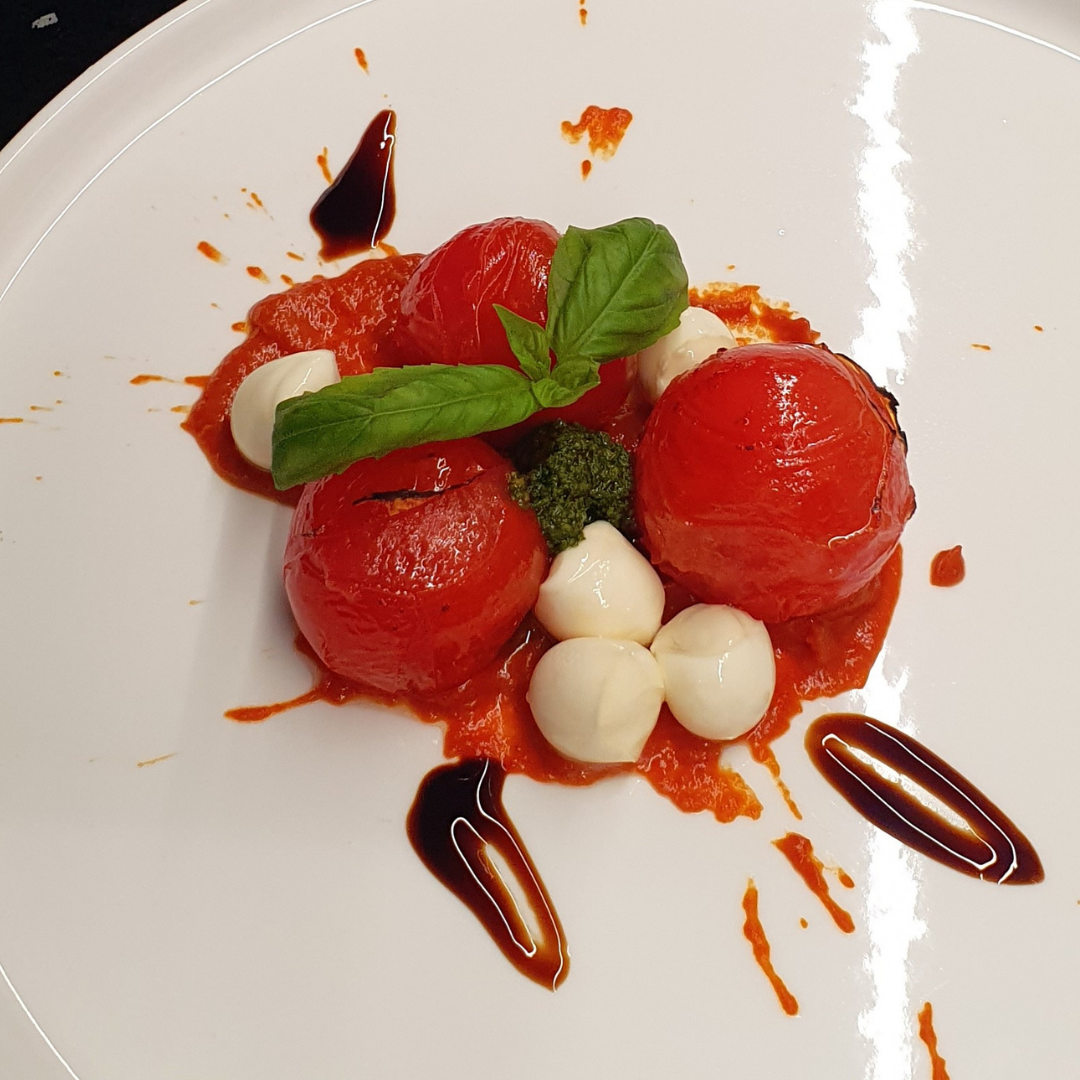 Blistered tomatoes with tomato vodka cream, pesto, bocconcini and balsamic glaze